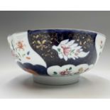 A Chinese export porcelain punch bowl, Qianlong Period, with shaped dark blue panels enclosing