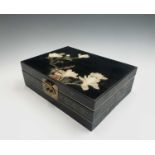A Chinese ebonised work box, early-mid 20th century, the cover decorated with a bird perched on a