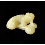 A Chinese jade carving of a recumbent hound, Qing dynasty, height 2.5cm, width 5cm, depth 3.5cm