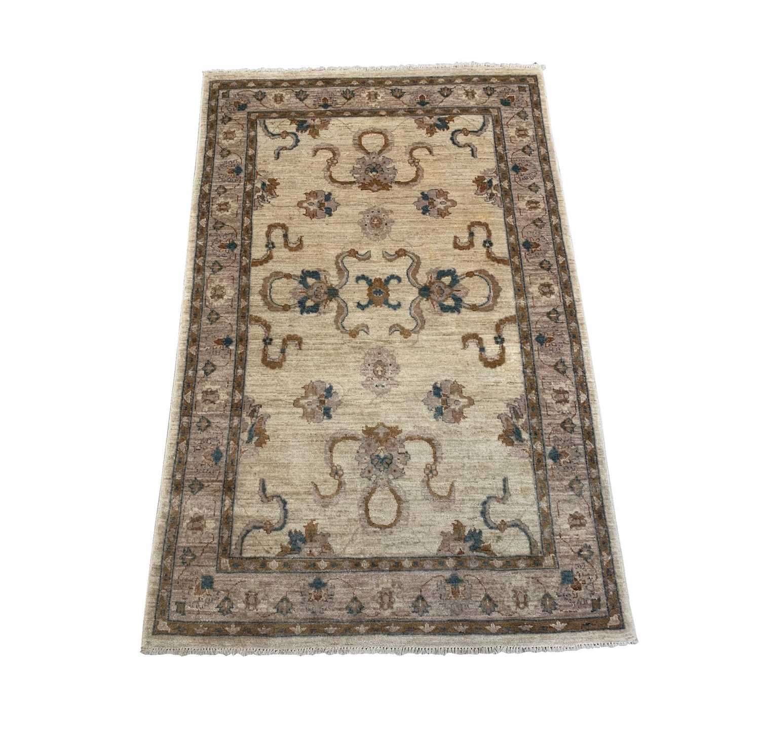 A Ziegler Chobi rug, the ivory field with palmettes and flowering vines, within a meandering