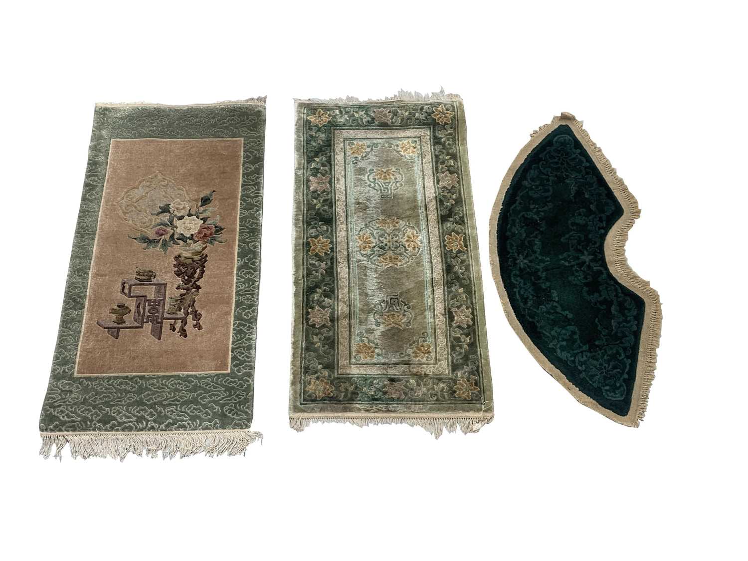 Two Chinese silk rugs, 126 x 62cm and 122 x 62cm and a Chinese woollen mat, 55 x 120cm.