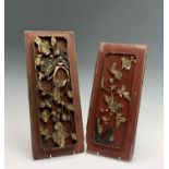 Two Chinese red painted carved wood panels, 19th century, with floral decoration and gilded