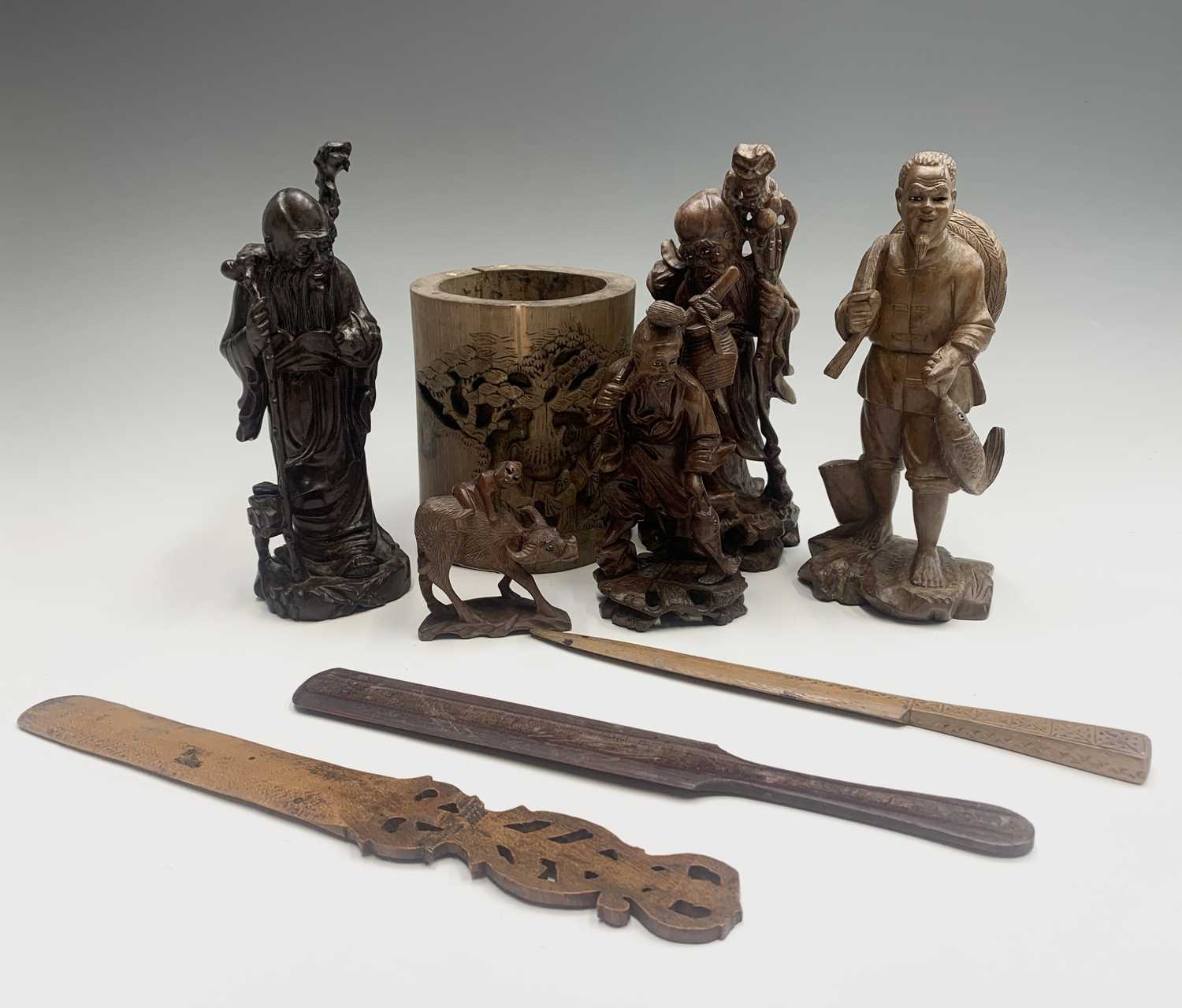 A Chinese hardwood figure of Shoulao, holding a peach and a staff, height 21cm, together with four