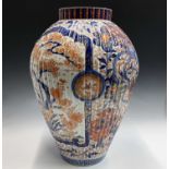 A large Japanese Imari floor standing porcelain vase, Meiji Period, the ribbed body and white ground