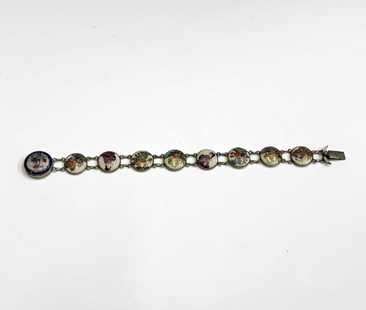 A Japanese Satsuma pottery and white metal bracelet, with nine roundels, full length 19.5cm.