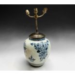 A Chinese blue and white porcelain baluster vase, 17th century, the body with floral sprays,
