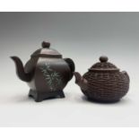 Two Chinese Yixing pottery teapots, with seal marks, the largest with floral enamel decoration,