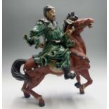 A large Chinese pottery figure of a warrior on horseback, seal mark, height 52cm.