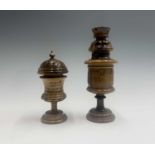 Two Jerusalem olive wood urns and covers, each with arabic calligraphy, heights 18.5cm and 14cm.