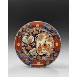 A Japanese Imari charger, late 19th century, with three Geisha girls, trees and flowers, the