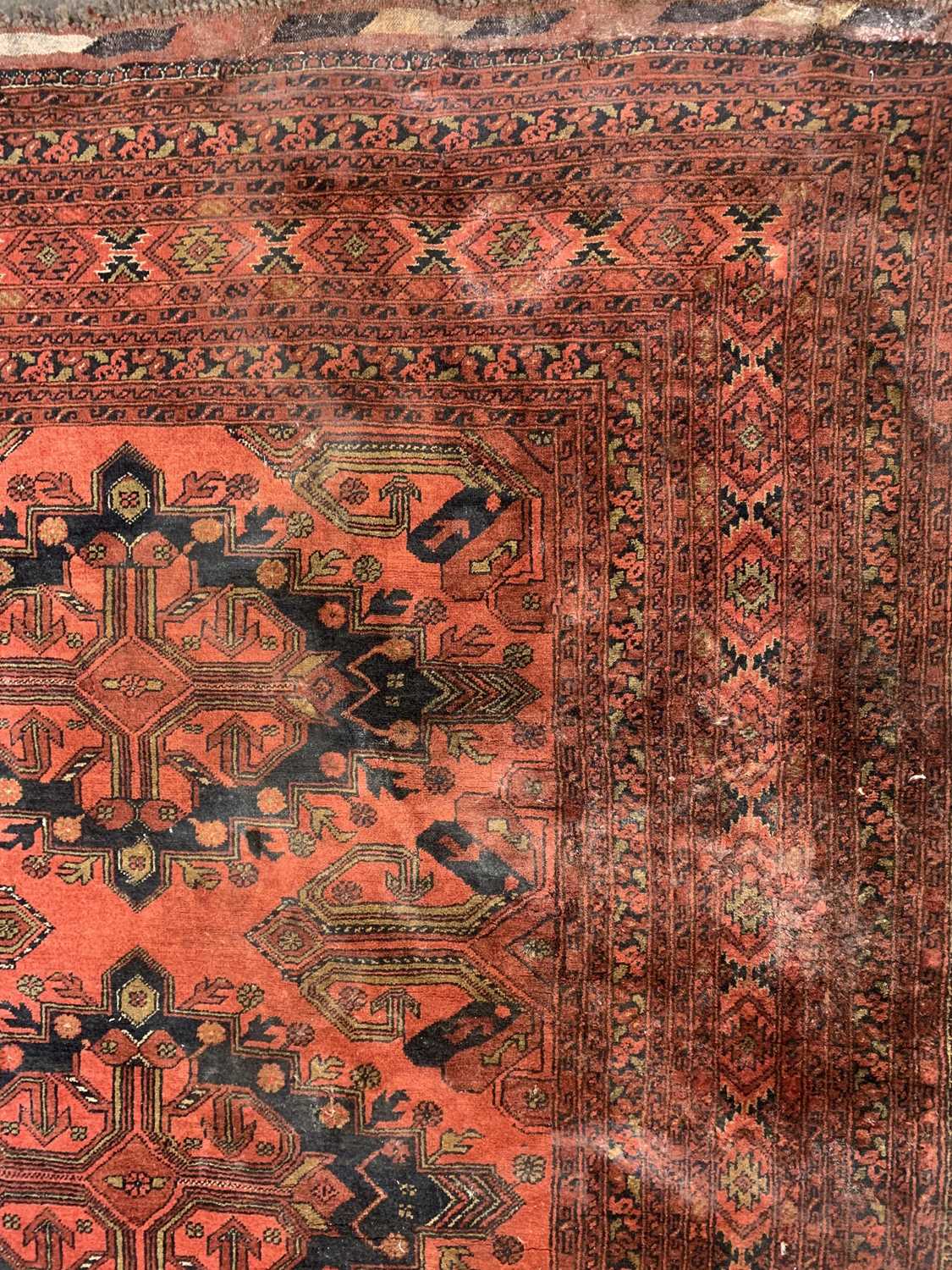 An Afghan carpet, mid 20th century, the madder field with five rows of two polychrome medallions, - Image 5 of 7