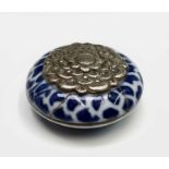 A Chinese blue and white cosmetic pot, probably Kangxi, with applied white metal chrysanthemum