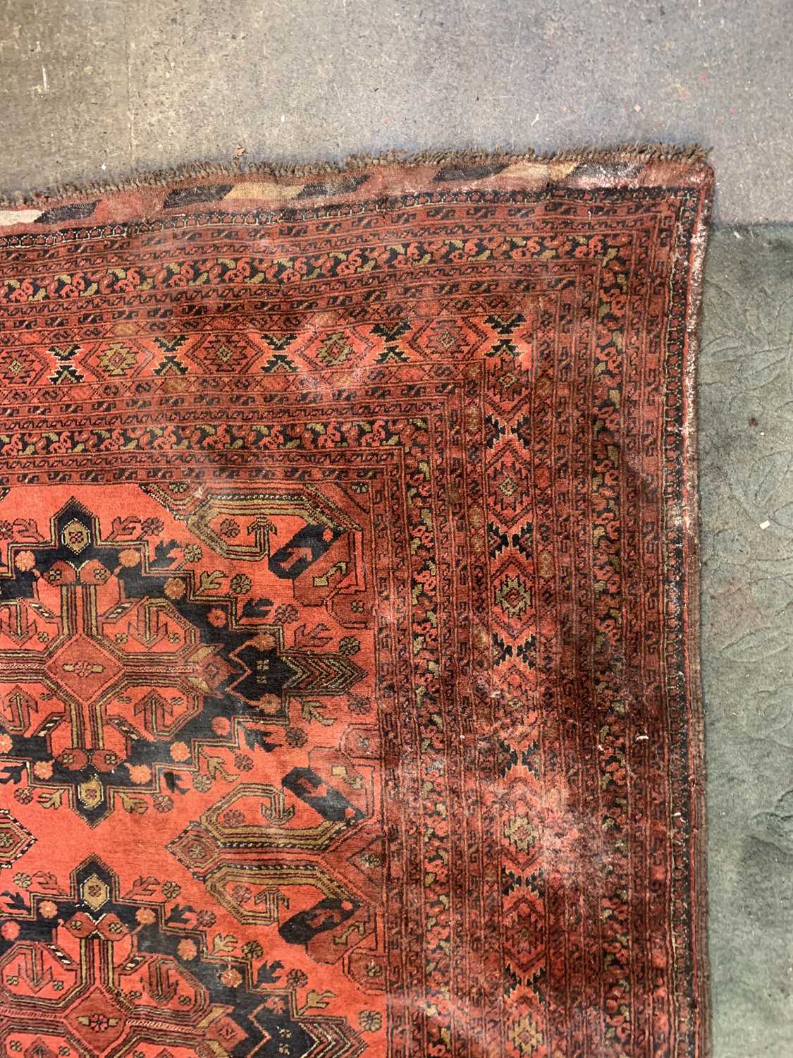 An Afghan carpet, mid 20th century, the madder field with five rows of two polychrome medallions, - Image 2 of 7