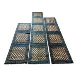 Three matching Chinese runners, 19th century, each with square trellis design medallions,
