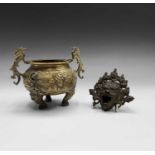 A Chinese bronze twin-handled censer, height 14cm and a Tibetan mask incense burner, length 11cm.