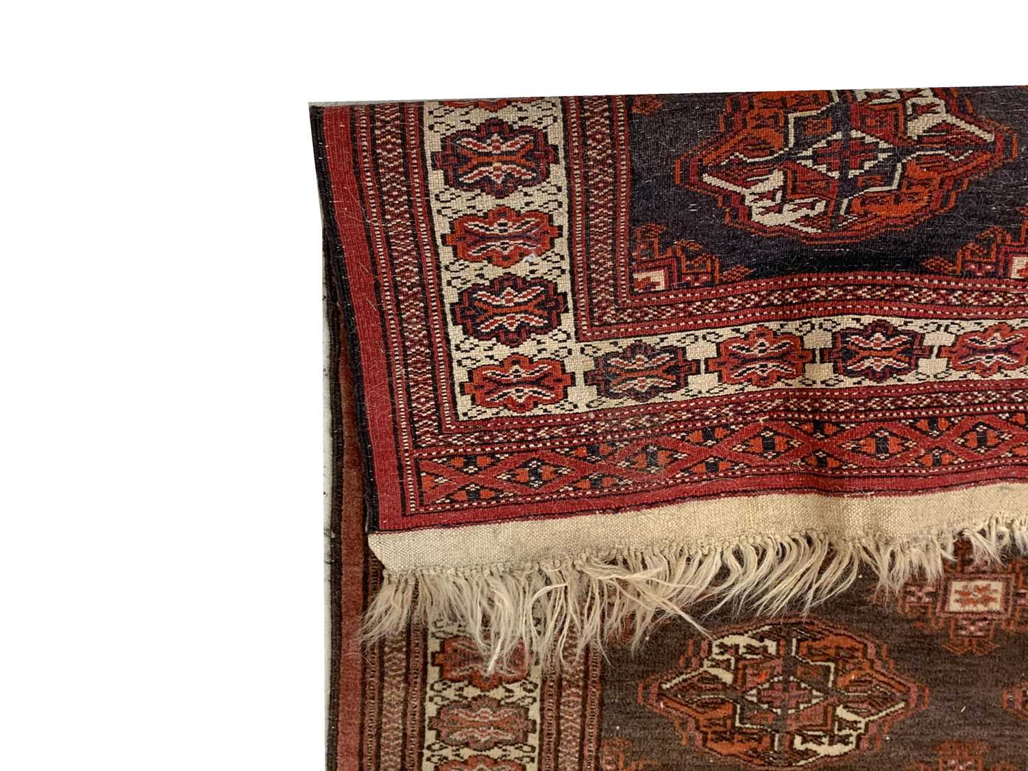 A Bokhara rug, early 20th century, the brown field with eight rows of three medallionsand rows of - Image 2 of 2