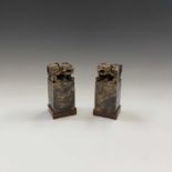 A pair of Chinese soapstone chops, of square form with character marks and surmounted by dogs of fo,