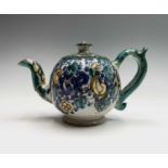 A Moroccan pottery teapot, 19th century, height 12cm, handle to spout 20cm.