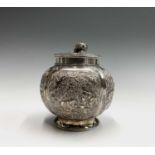 A Chinese silver globular tea caddy, the body with four shaped panels enclosing garden scenes