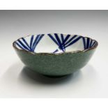 A Japanese Arita style blue and white porcelain bowl, 19th century, with an apple green outer glaze,