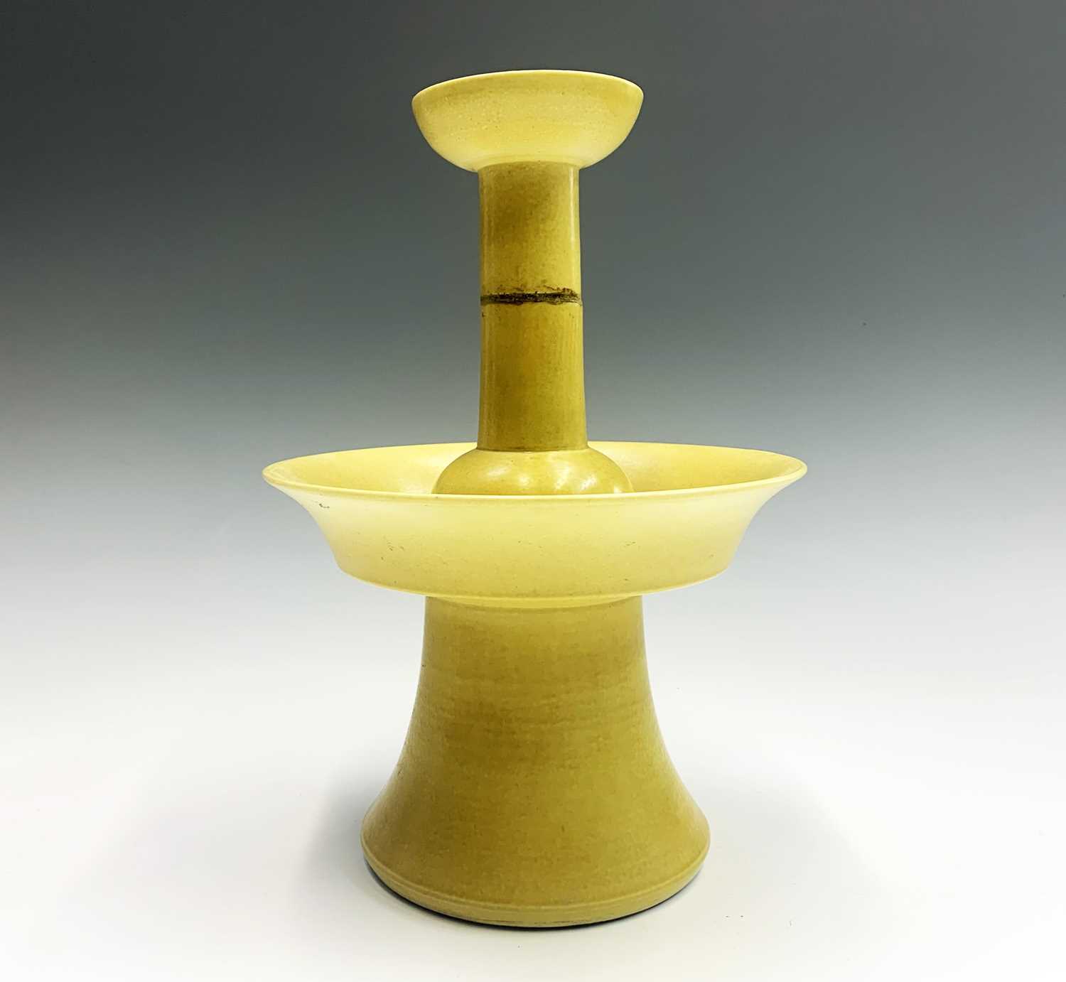 A Chinese yellow glazed porcelain candlestick holder, 18th/19th century, with a four-character