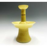 A Chinese yellow glazed porcelain candlestick holder, 18th/19th century, with a four-character