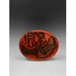 A Japanese red lacquer tray, early 20th century, depicting a koi carp, paper label to verso, 28 x