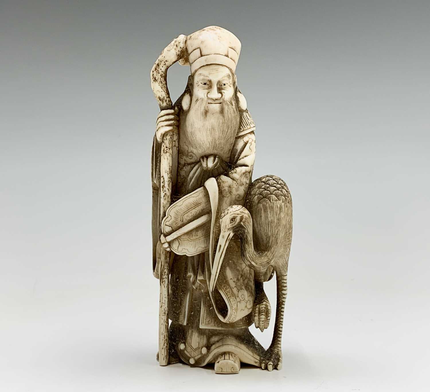 A Chinese carved ivory figure of Shouxing, 19th century, character marks, with staff in hand