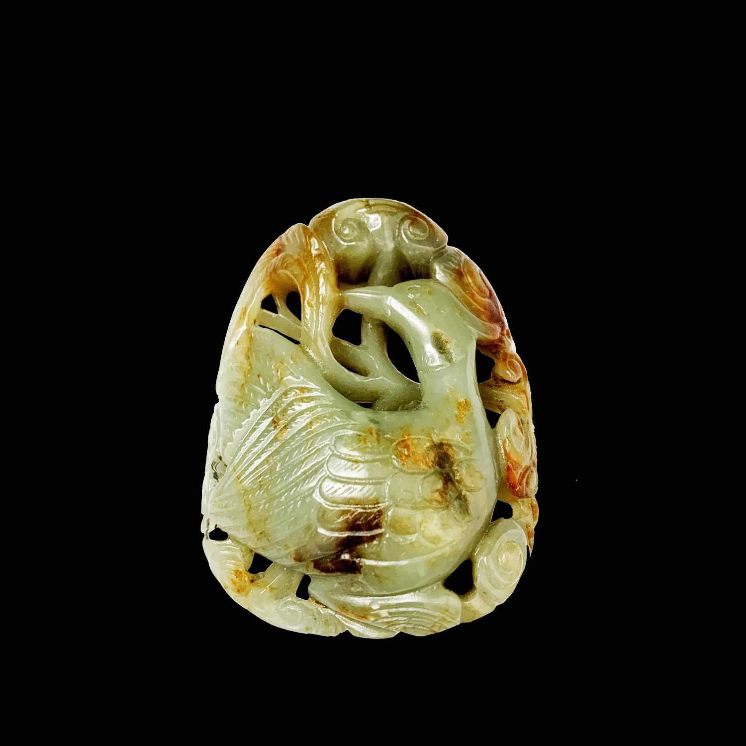 A Chinese carved & reticulated celadon jade ornament, depicting a bird & lingzhi, with russet