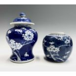A Chinese blue and white prunus blossom vase and cover, height 21cm and a similar ginger jar, height