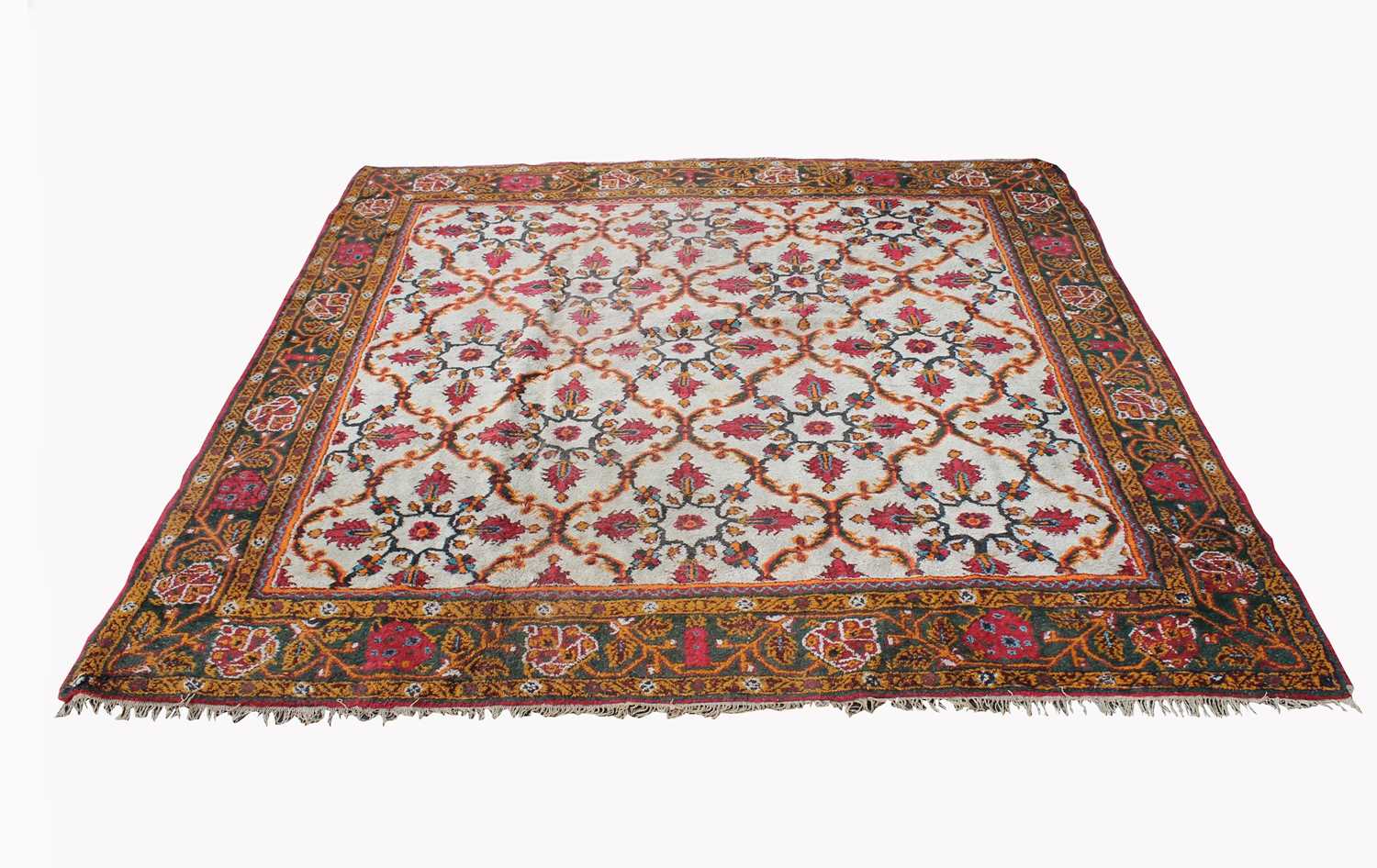 An Indian carpet, circa 1920, the ivory field with all over trellis design enclosing palmettes,