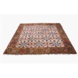 An Indian carpet, circa 1920, the ivory field with all over trellis design enclosing palmettes,
