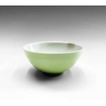 A Chinese lime-green monochrome porcelain wine cup, Yongzheng six character mark and attached