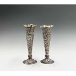 A pair of Indian silver bud vases, early 20th century, decorated with scrolling flowering vines,