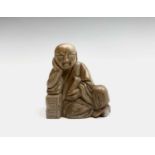 A small Chinese hardstone carving of a reclining Buddha, height 6cm, width 5.5cm.