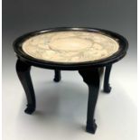 A Chinese ebonised occasional table, circa 1930's, the glazed top above a circular silk