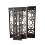 A Chinese carved wood screen, 19th century, the four rectangular panels each foliate carved to the