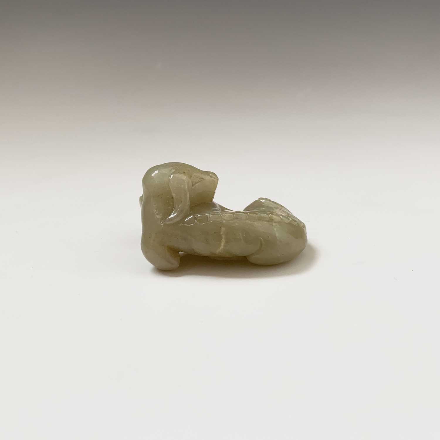 A Chinese jade carving of a recumbent hound, Qing dynasty, height 2.5cm, width 5cm, depth 3.5cm - Image 2 of 9
