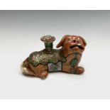 A Chinese Canton porcelain lion dog candlestick holder, 19th century, wearing a lotus flower gilt