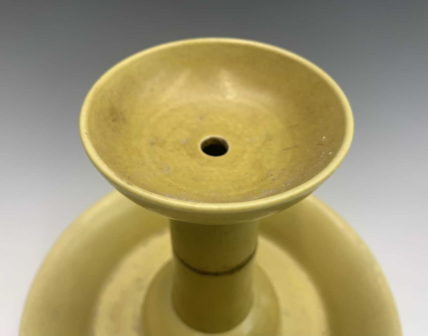 A Chinese yellow glazed porcelain candlestick holder, 18th/19th century, with a four-character - Image 7 of 28