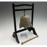 A Chinese brass bell shape gong on ebonised stand, height 38cm.