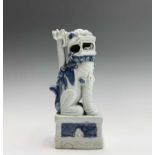A Chinese blue and white porcelain dog of fo, seated on a plinth, height 23cm.