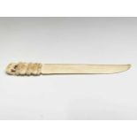 An Indian carved ivory letter opener, late 19th century, the handle surmounted by an elephant,
