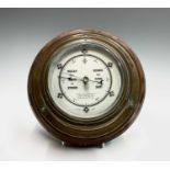 A brass cased aneroid barometer, with presentation inscription dated 1917, mounted on a mahogany
