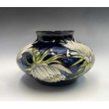 A Moorcroft 'Queen of the Night' pattern squat vase, designed by Anji Davenport, having tube lined