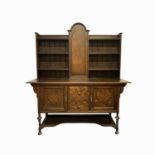 A Shapland & Petter dark oak dresser in William and Mary style, the doors with coloured inlays of