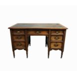 An Edwardian walnut pedestal desk, the rectangular top with a blue leather inset, above an