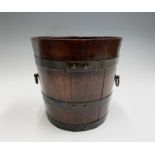 An Edwardian teak jardiniere, of copper banded coopered construction with twin loop handles,
