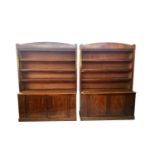 A pair of late Victorian mahogany open library bookcases, each with an arched cornice above four