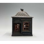An American painted cast iron 'Home Savings Bank' money box, with dog head finial, the base with